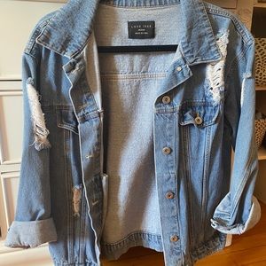 Distressed denim jacket. Oversized fit